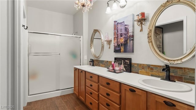 7723 Widewing Dr, North Las Vegas, NV 89084 - bathroom with a stall shower, double vanity, and wood finished floors