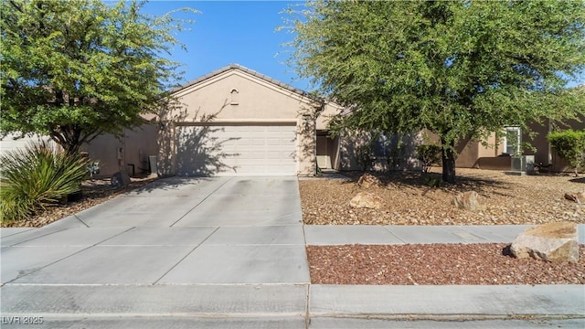 7723 Widewing Dr, North Las Vegas, NV 89084 - view of front facade featuring stucco siding, concrete driveway, and an attached garage