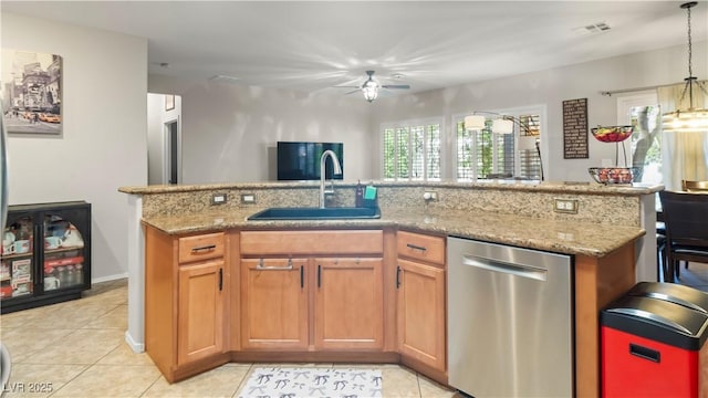 7723 Widewing Dr, North Las Vegas, NV 89084 - kitchen with stainless steel dishwasher, a ceiling fan, light tile patterned floors, and a kitchen island with sink