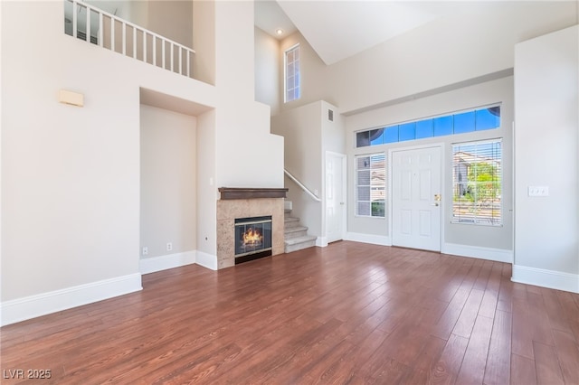 258 Horizon Pointe Cir, Henderson, NV 89012 - entrance foyer featuring dark wood-type flooring, a towering ceiling, stairway, and a tile fireplace