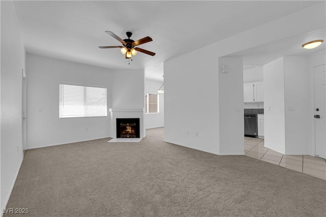 8501 W University Ave Unit 2053, Las Vegas, NV 89147 - unfurnished living room with light carpet, a ceiling fan, a fireplace with flush hearth, and light tile patterned floors
