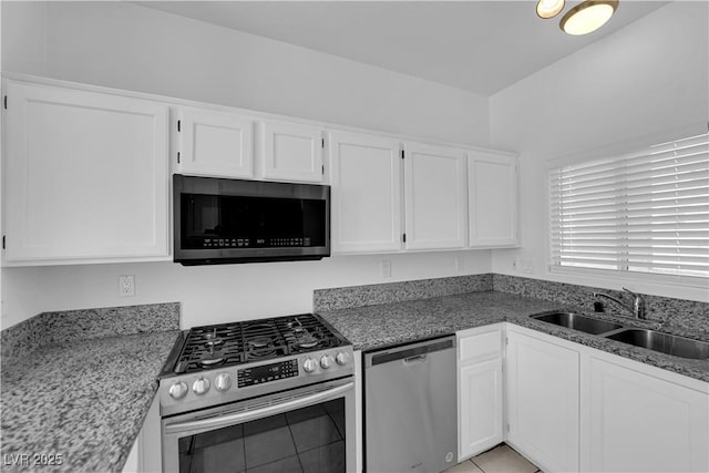 8501 W University Ave Unit 2053, Las Vegas, NV 89147 - kitchen with stainless steel appliances, white cabinets, and light stone counters