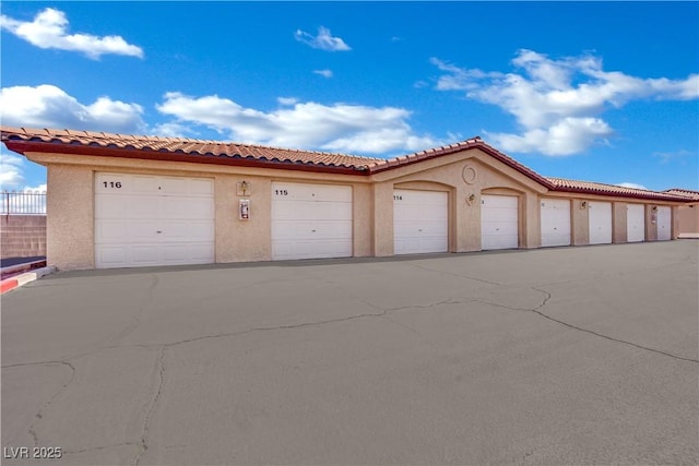 8501 W University Ave Unit 2053, Las Vegas, NV 89147 - view of front of home with stucco siding, community garages, and a tile roof
