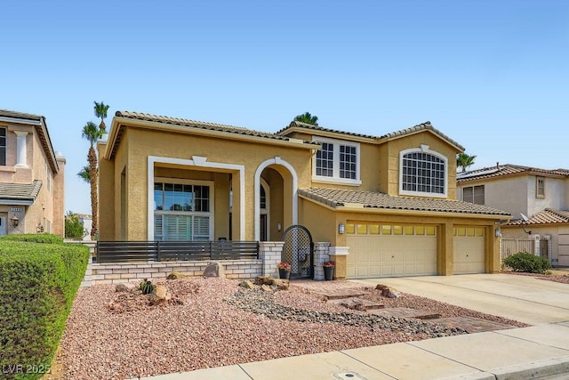 2458 Tour Edition Dr, Henderson, NV 89074 - view of front of property featuring stucco siding, an attached garage, driveway, a tiled roof, and a porch