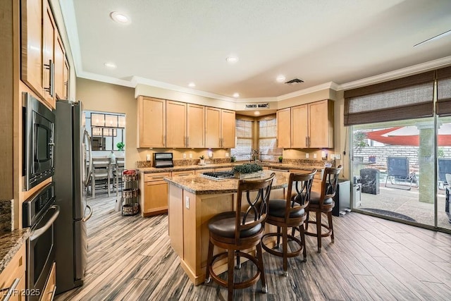 2458 Tour Edition Dr, Henderson, NV 89074 - kitchen with appliances with stainless steel finishes, light brown cabinetry, a kitchen island, a kitchen bar, and crown molding
