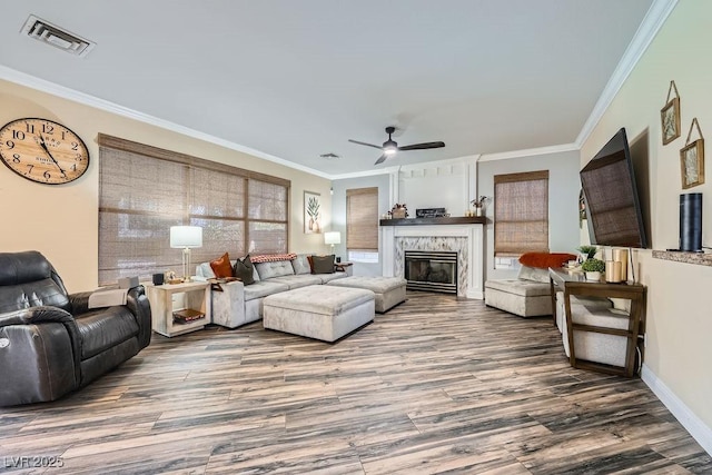 2458 Tour Edition Dr, Henderson, NV 89074 - living area featuring wood finished floors, crown molding, a ceiling fan, and a glass covered fireplace