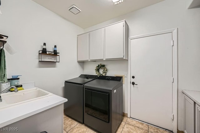 2458 Tour Edition Dr, Henderson, NV 89074 - laundry room featuring cabinet space, separate washer and dryer, and light tile patterned floors
