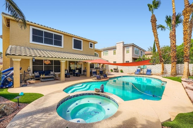 2458 Tour Edition Dr, Henderson, NV 89074 - view of swimming pool featuring outdoor lounge area, a patio area, a pool with connected hot tub, and a fenced backyard