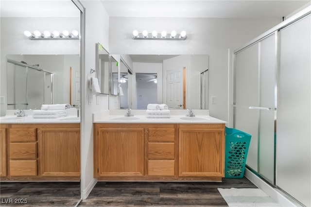 8179 Palace Monaco Ave, Las Vegas, NV 89117 - bathroom featuring a shower stall, double vanity, and wood finished floors