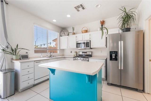8179 Palace Monaco Ave, Las Vegas, NV 89117 - kitchen featuring stainless steel appliances, light tile patterned floors, light countertops, white cabinetry, and recessed lighting