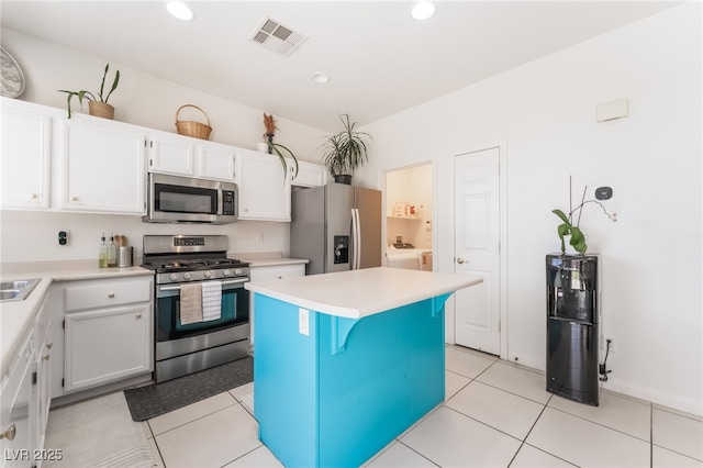 8179 Palace Monaco Ave, Las Vegas, NV 89117 - kitchen featuring stainless steel appliances, a center island, a kitchen breakfast bar, light countertops, and white cabinetry