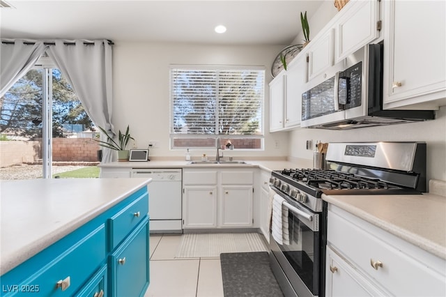 8179 Palace Monaco Ave, Las Vegas, NV 89117 - kitchen featuring appliances with stainless steel finishes, blue cabinetry, white cabinetry, light countertops, and recessed lighting