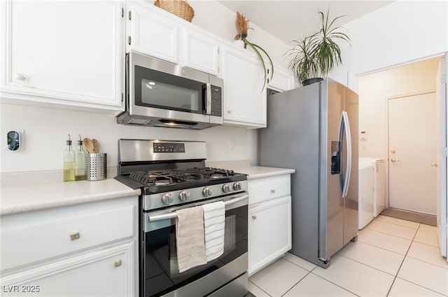 8179 Palace Monaco Ave, Las Vegas, NV 89117 - kitchen with stainless steel appliances, washing machine and dryer, white cabinets, light countertops, and light tile patterned floors