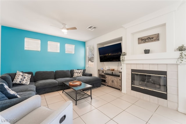 8179 Palace Monaco Ave, Las Vegas, NV 89117 - living room with ceiling fan, a fireplace, and light tile patterned floors