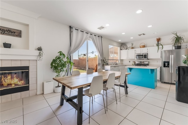 8179 Palace Monaco Ave, Las Vegas, NV 89117 - dining space with recessed lighting, a tiled fireplace, and light tile patterned floors