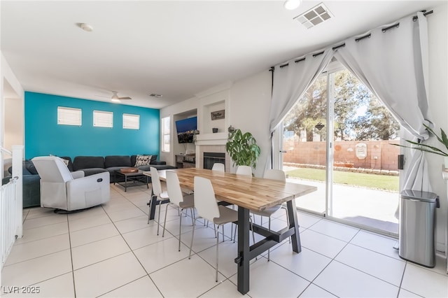 8179 Palace Monaco Ave, Las Vegas, NV 89117 - dining area with light tile patterned floors and a tiled fireplace