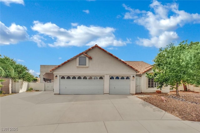 4423 Sophia Way N, Las Vegas, NV 89032 - mediterranean / spanish-style house with a garage, concrete driveway, stucco siding, and a tile roof