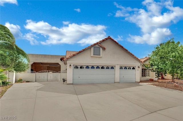 4423 Sophia Way N, Las Vegas, NV 89032 - mediterranean / spanish-style home with driveway, a gate, an attached garage, stucco siding, and a tile roof