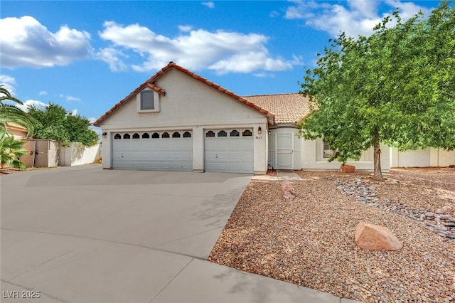 4423 Sophia Way N, Las Vegas, NV 89032 - mediterranean / spanish-style house with concrete driveway, an attached garage, stucco siding, and a tile roof