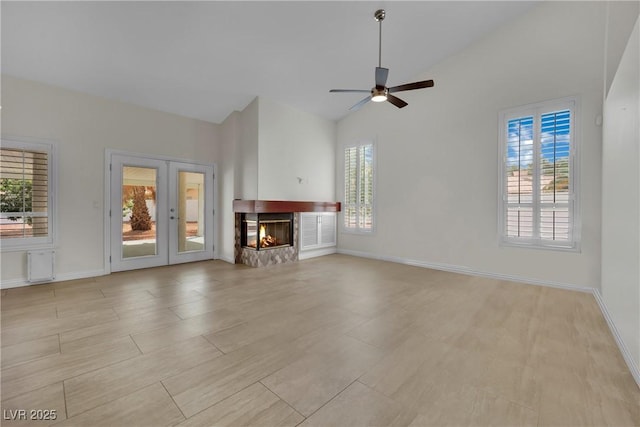 4423 Sophia Way N, Las Vegas, NV 89032 - unfurnished living room featuring french doors, a ceiling fan, a multi sided fireplace, and high vaulted ceiling