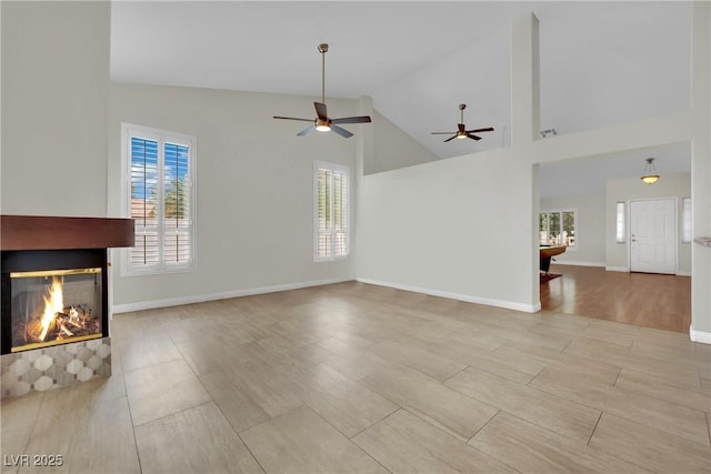 4423 Sophia Way N, Las Vegas, NV 89032 - unfurnished living room featuring a multi sided fireplace, a ceiling fan, and high vaulted ceiling
