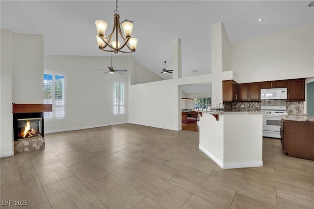 4423 Sophia Way N, Las Vegas, NV 89032 - kitchen with white appliances, ceiling fan, a chandelier, open floor plan, and high vaulted ceiling