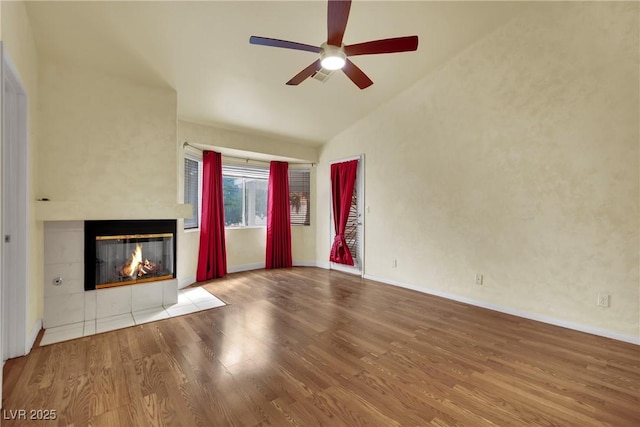 4423 Sophia Way N, Las Vegas, NV 89032 - unfurnished living room with lofted ceiling, a tile fireplace, wood finished floors, and a ceiling fan