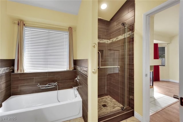 4423 Sophia Way N, Las Vegas, NV 89032 - bathroom with a stall shower, a garden tub, and wood finished floors