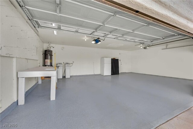 4423 Sophia Way N, Las Vegas, NV 89032 - garage with strapped water heater, refrigerator, and a garage door opener