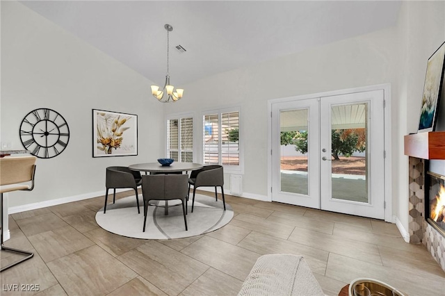 4423 Sophia Way N, Las Vegas, NV 89032 - dining space featuring a chandelier, lofted ceiling, french doors, and a glass covered fireplace