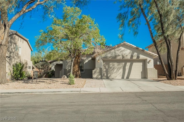 2547 Sundew Ave, Henderson, NV 89052 - view of front of property featuring an attached garage, stucco siding, concrete driveway, and a tiled roof