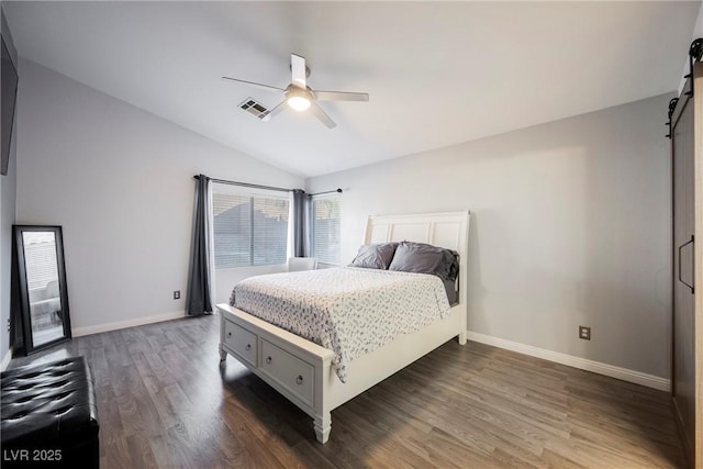 2547 Sundew Ave, Henderson, NV 89052 - bedroom featuring a barn door, vaulted ceiling, dark wood-type flooring, and a ceiling fan