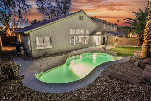 2547 Sundew Ave, Henderson, NV 89052 - back of property featuring a patio, a fenced backyard, and stucco siding