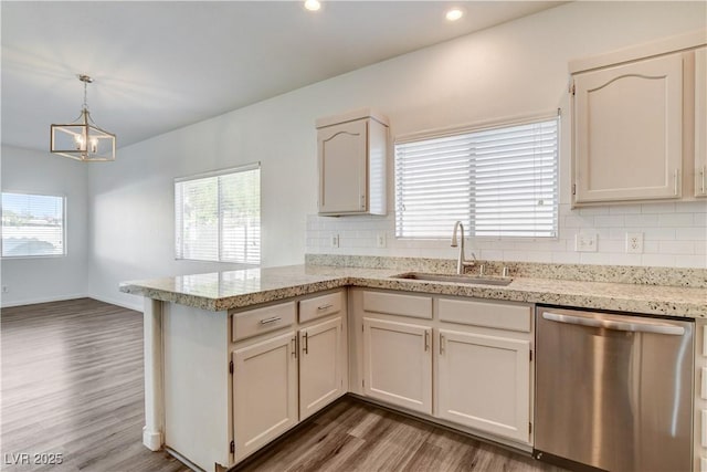 9520 Silver Frost St, Las Vegas, NV 89123 - kitchen with dishwasher, a peninsula, dark wood-style flooring, backsplash, and a chandelier