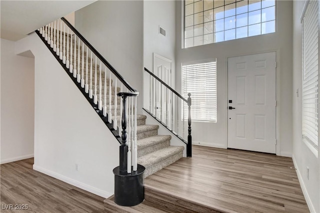 9520 Silver Frost St, Las Vegas, NV 89123 - foyer featuring wood finished floors, stairs, healthy amount of natural light, and a high ceiling