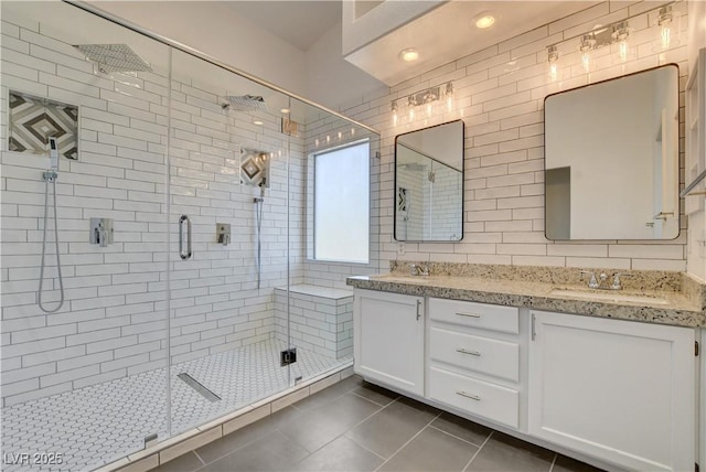 9520 Silver Frost St, Las Vegas, NV 89123 - bathroom featuring tile patterned floors, double vanity, a shower stall, and tile walls
