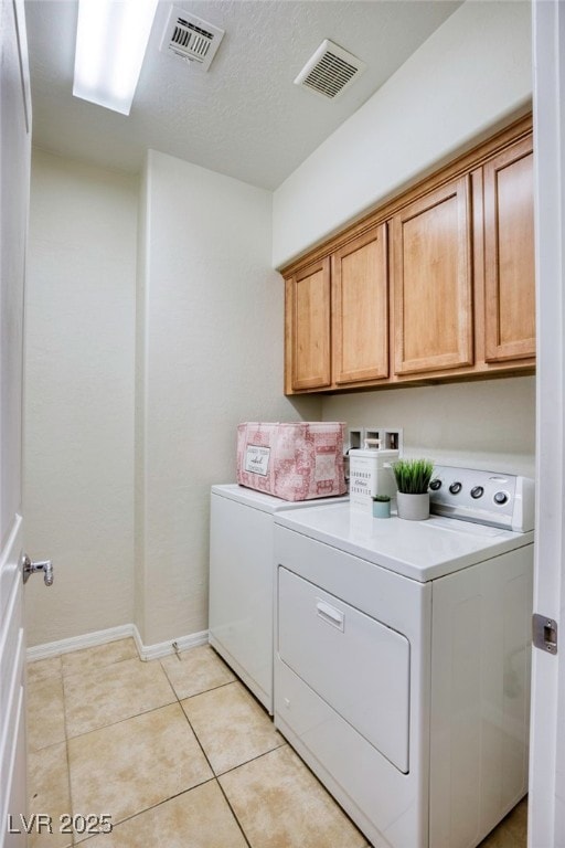 2425 Sky Watcher St, Henderson, NV 89044 - laundry room with cabinet space, washer and dryer, and light tile patterned floors