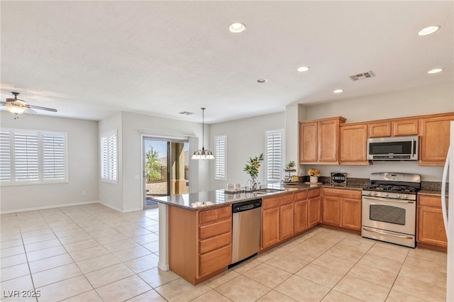 2425 Sky Watcher St, Henderson, NV 89044 - kitchen featuring appliances with stainless steel finishes, a peninsula, light tile patterned flooring, recessed lighting, and ceiling fan