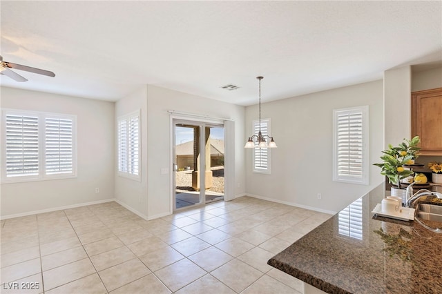 2425 Sky Watcher St, Henderson, NV 89044 - unfurnished dining area with plenty of natural light, ceiling fan, light tile patterned floors, and a chandelier