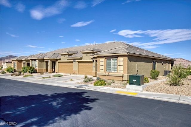 2425 Sky Watcher St, Henderson, NV 89044 - view of front of home featuring stucco siding, concrete driveway, a garage, and a tile roof
