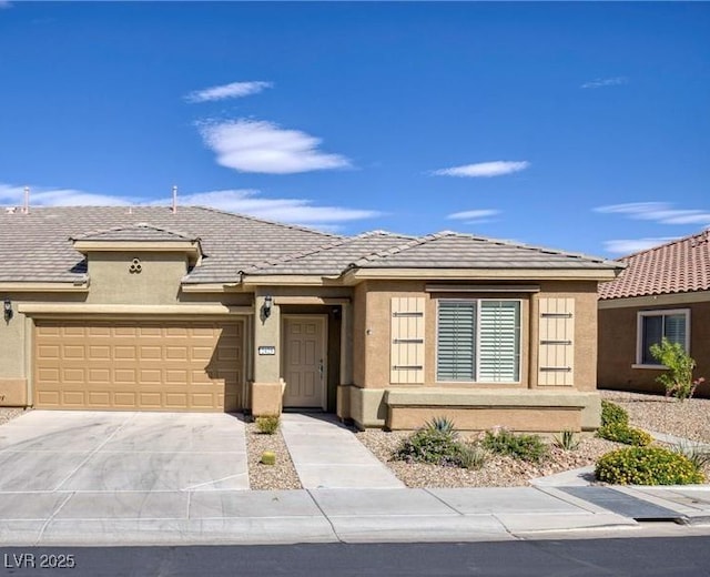 2425 Sky Watcher St, Henderson, NV 89044 - view of front of property featuring stucco siding, an attached garage, and concrete driveway