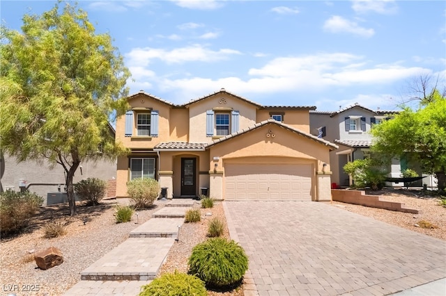 1152 Highbury Grove St, Henderson, NV 89002 - mediterranean / spanish-style home featuring stucco siding, decorative driveway, a garage, and a tiled roof
