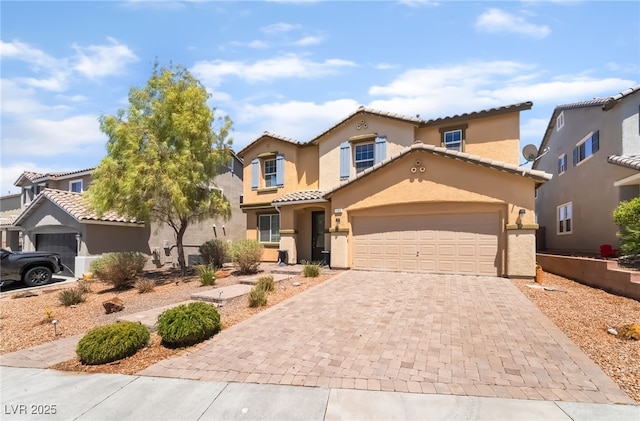 1152 Highbury Grove St, Henderson, NV 89002 - mediterranean / spanish home featuring decorative driveway, stucco siding, and a tile roof