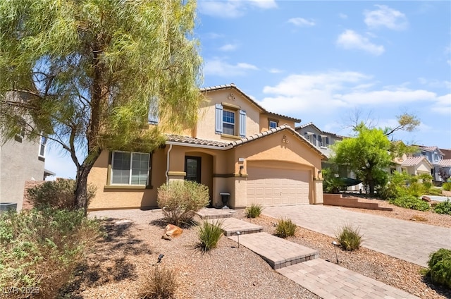 1152 Highbury Grove St, Henderson, NV 89002 - mediterranean / spanish home featuring stucco siding, a tiled roof, and decorative driveway