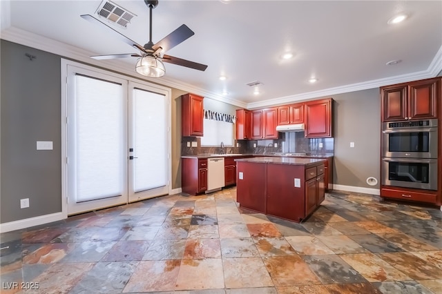 1152 Highbury Grove St, Henderson, NV 89002 - kitchen with dishwasher, stainless steel double oven, reddish brown cabinets, crown molding, and a kitchen island