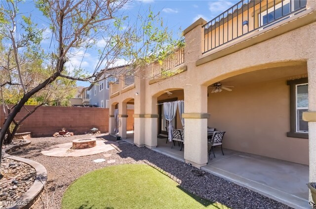 1152 Highbury Grove St, Henderson, NV 89002 - view of yard with a balcony, a fire pit, a patio area, and ceiling fan