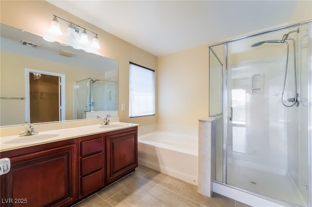 1152 Highbury Grove St, Henderson, NV 89002 - full bath featuring a stall shower, a bath, double vanity, a walk in closet, and tile patterned flooring