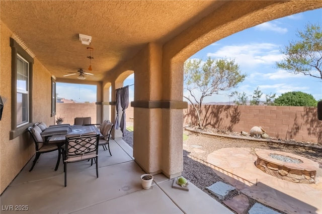 1152 Highbury Grove St, Henderson, NV 89002 - fenced backyard featuring an outdoor fire pit, ceiling fan, a patio, and outdoor dining space