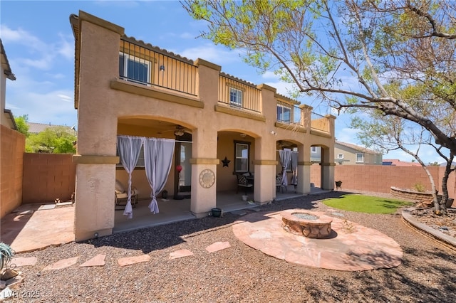 1152 Highbury Grove St, Henderson, NV 89002 - rear view of property with a balcony, a patio, stucco siding, a fenced backyard, and a fire pit