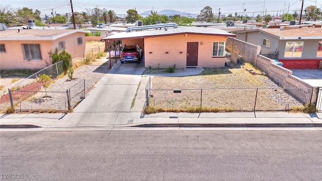304 N Minnesota St, Las Vegas, NV 89107 - view of front of property featuring concrete driveway, a fenced front yard, and a carport